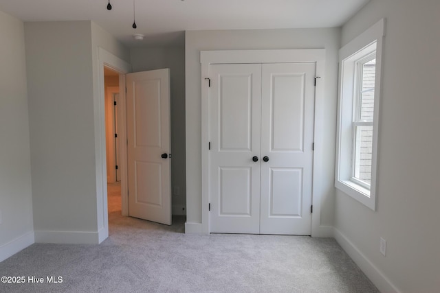 bathroom featuring baseboards, vanity, wood finished floors, and a marble finish shower