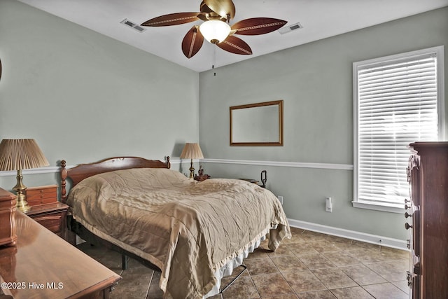 tiled bedroom featuring ceiling fan