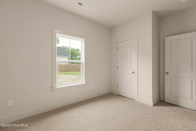 unfurnished bedroom featuring light carpet