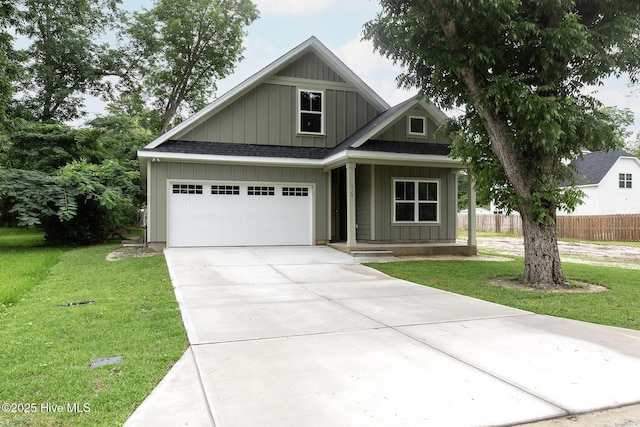 view of front of home featuring a front lawn and a garage