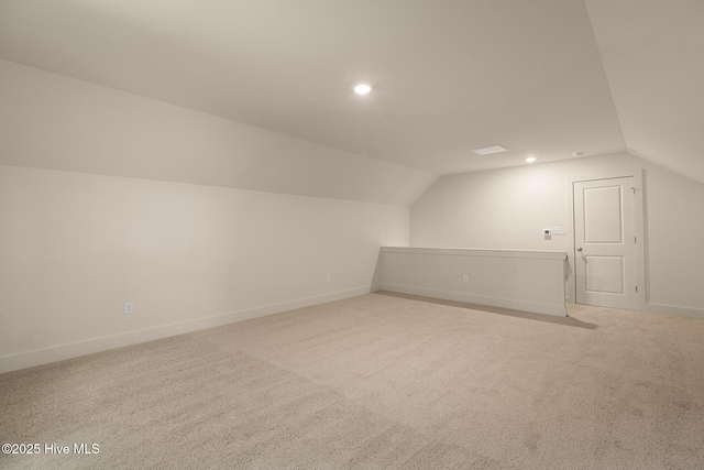 bonus room with light carpet and lofted ceiling