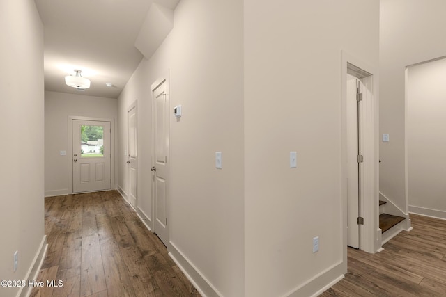 corridor with hardwood / wood-style flooring