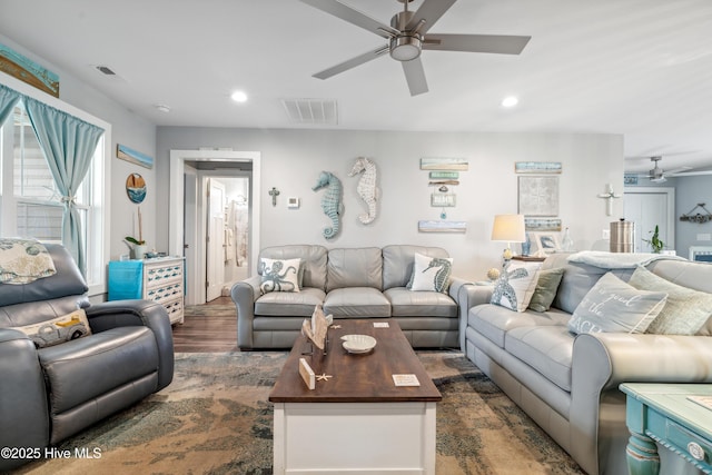 living room with dark hardwood / wood-style flooring and ceiling fan