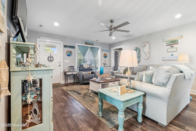 living room with dark hardwood / wood-style flooring and ceiling fan