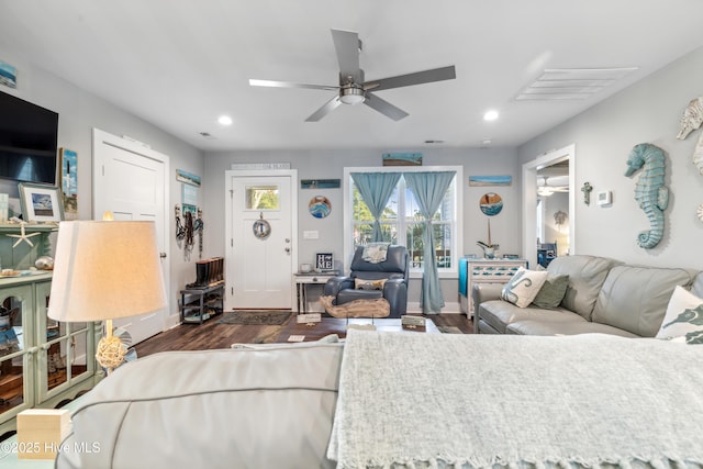 living room with dark wood-type flooring and ceiling fan