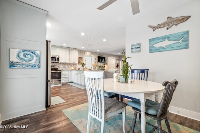 dining area featuring ceiling fan and dark hardwood / wood-style floors