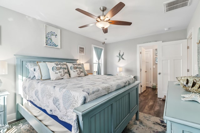 bedroom with dark wood-type flooring and ceiling fan