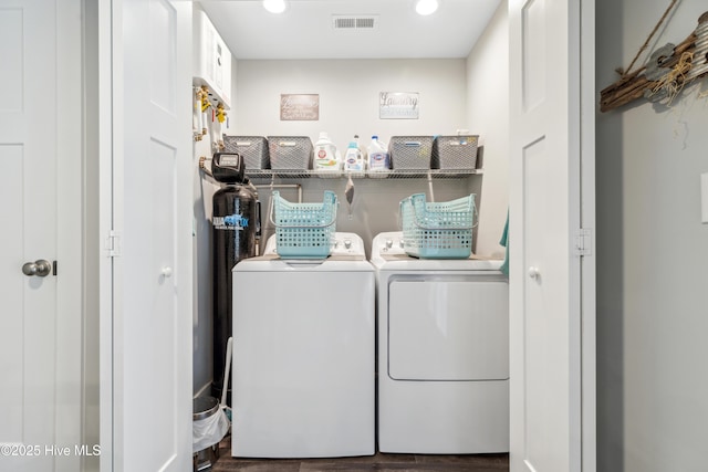 washroom featuring dark hardwood / wood-style flooring and washer and clothes dryer