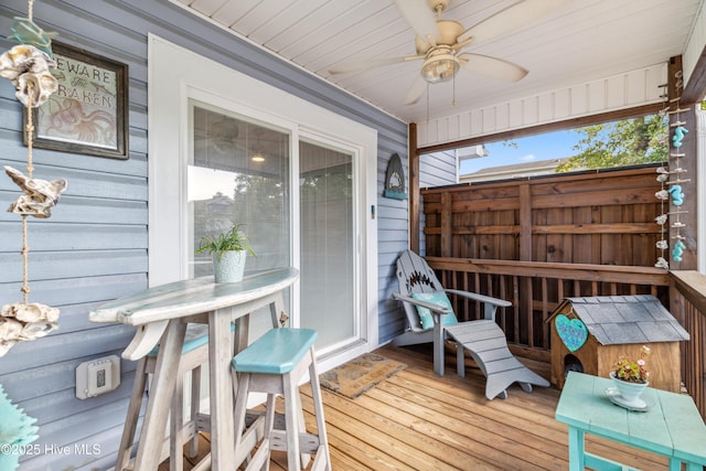 wooden terrace featuring ceiling fan