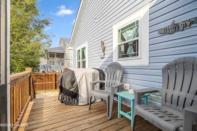 wooden terrace featuring a grill