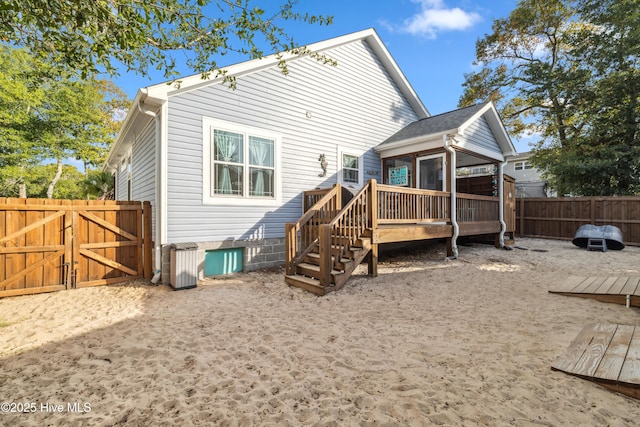 back of house with a wooden deck