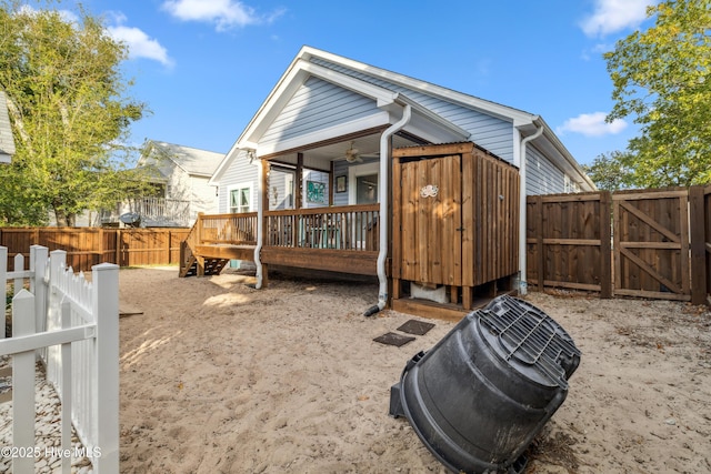 rear view of house with ceiling fan and a deck