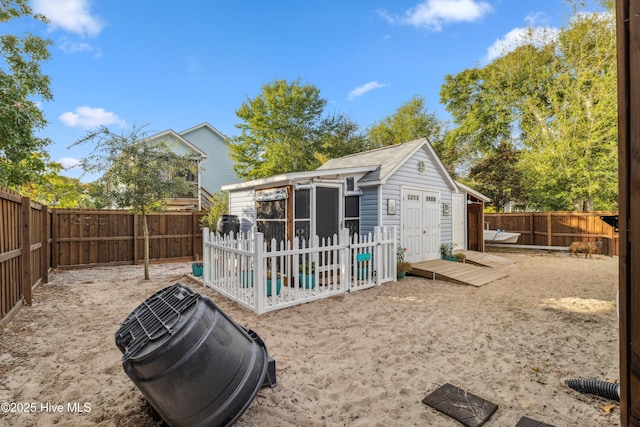 rear view of property with an outdoor structure