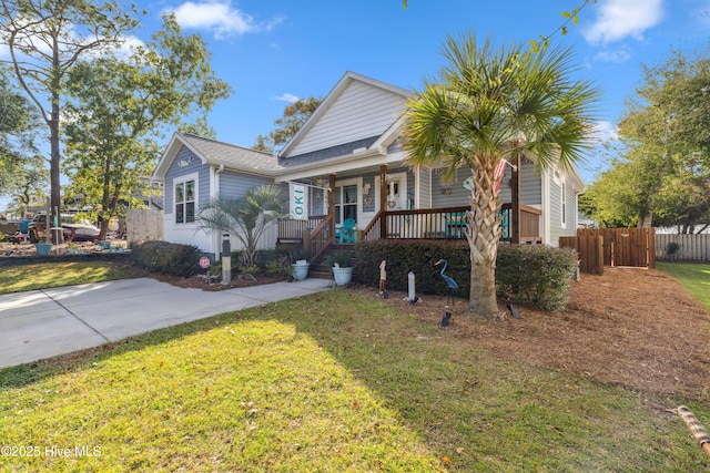 bungalow-style house with a front yard and covered porch