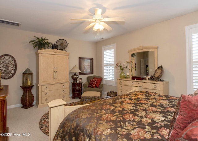 carpeted bedroom featuring visible vents, baseboards, and a ceiling fan