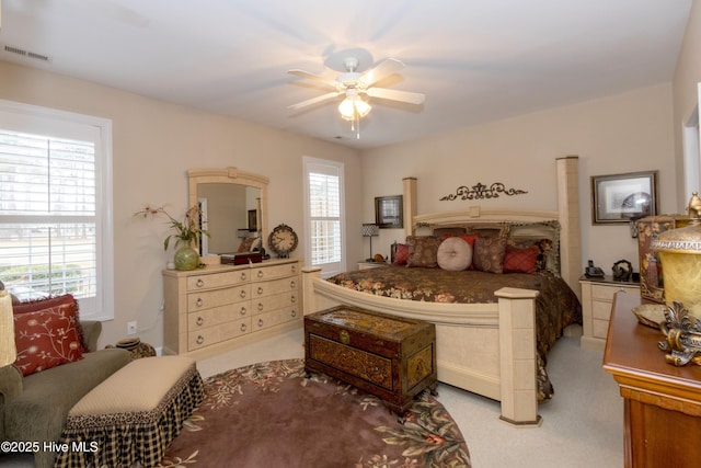 bedroom featuring a ceiling fan, carpet, and visible vents