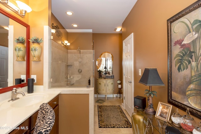 bathroom featuring tile patterned floors, recessed lighting, a walk in shower, and vanity