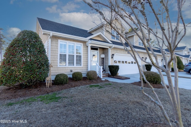 view of front facade with an attached garage and a shingled roof