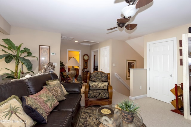 carpeted living area featuring a ceiling fan, visible vents, and baseboards