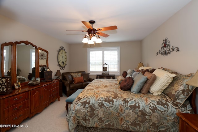 bedroom featuring light colored carpet and ceiling fan