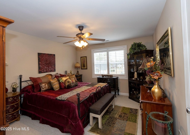 carpeted bedroom with baseboards and ceiling fan