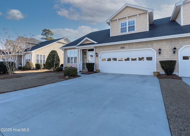 view of front of house featuring a garage, roof with shingles, and driveway