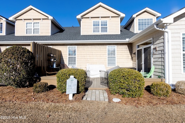 exterior space with roof with shingles