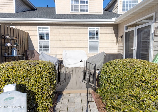 exterior space featuring a shingled roof