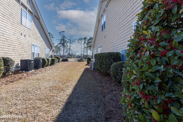 view of yard featuring central air condition unit