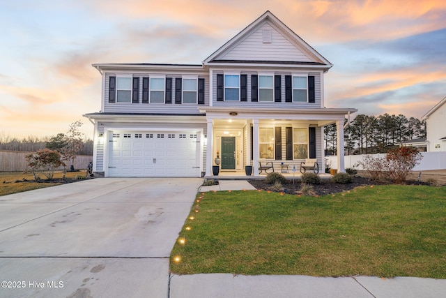 view of front of house with a porch, a garage, and a lawn