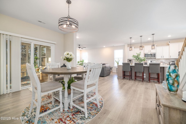 dining space featuring ceiling fan and light hardwood / wood-style flooring