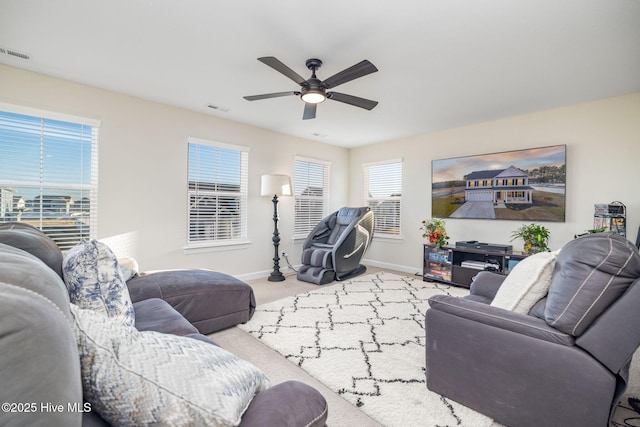 living room featuring carpet floors and ceiling fan