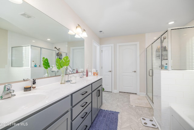 bathroom featuring vanity and shower with separate bathtub