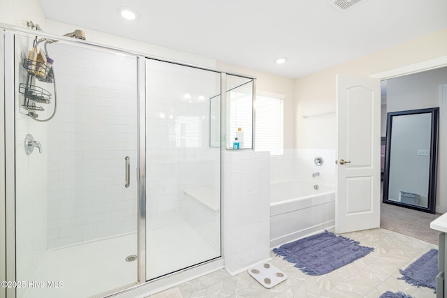 bathroom featuring separate shower and tub