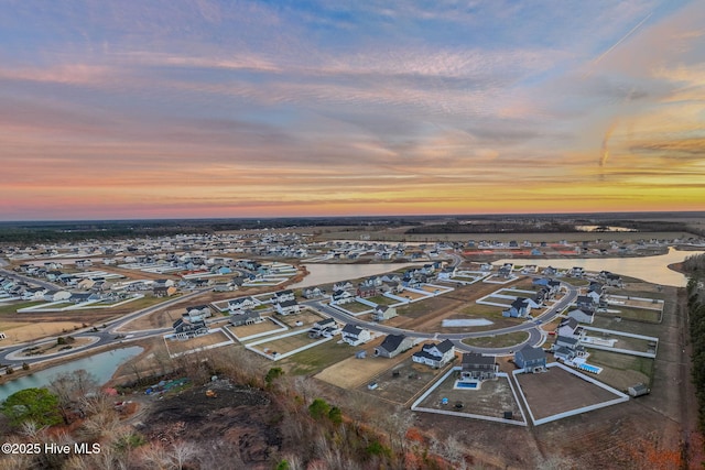 aerial view at dusk with a water view