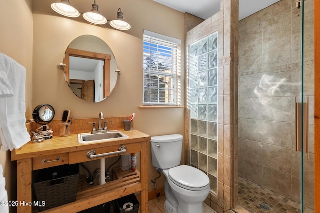 bathroom with vanity, a shower with shower door, and toilet