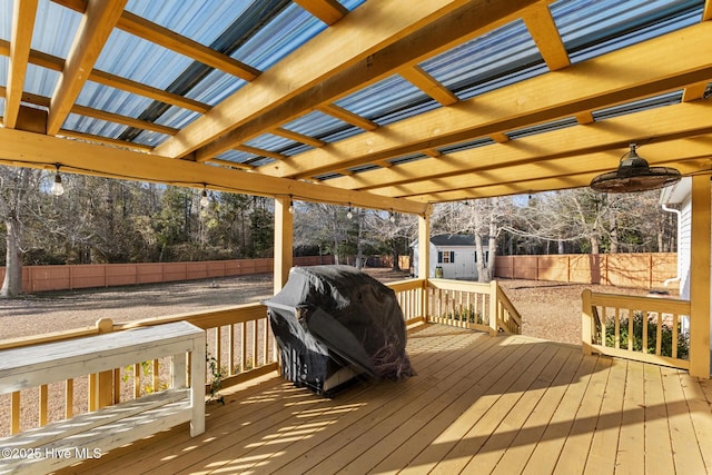 wooden deck featuring ceiling fan, a pergola, a shed, and a grill