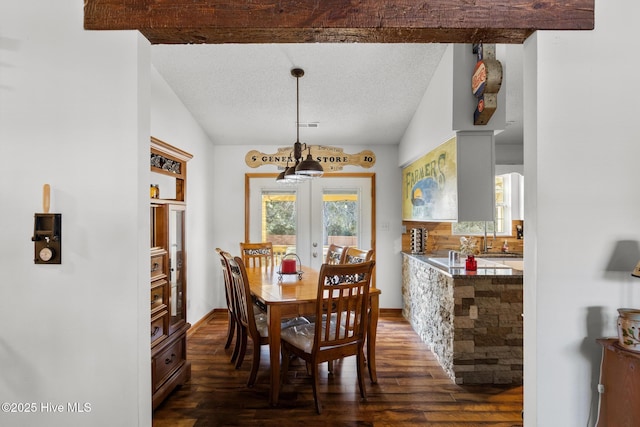 dining room featuring dark hardwood / wood-style flooring, french doors, and vaulted ceiling