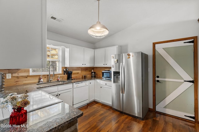 kitchen featuring white cabinetry, sink, decorative light fixtures, stainless steel appliances, and dark hardwood / wood-style floors