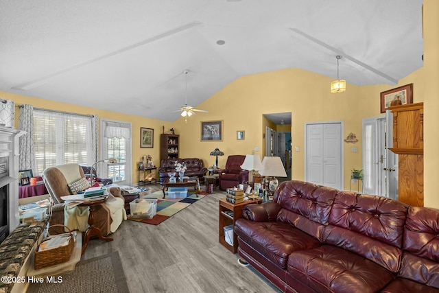 living room featuring ceiling fan, light hardwood / wood-style flooring, and lofted ceiling