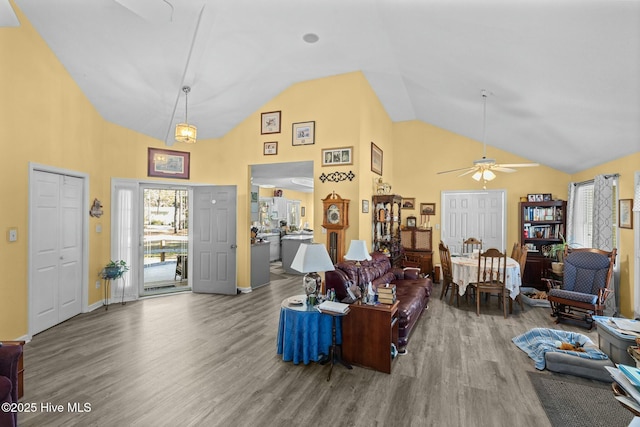 living room featuring hardwood / wood-style flooring, high vaulted ceiling, and ceiling fan