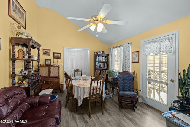 dining space with ceiling fan, wood-type flooring, and lofted ceiling