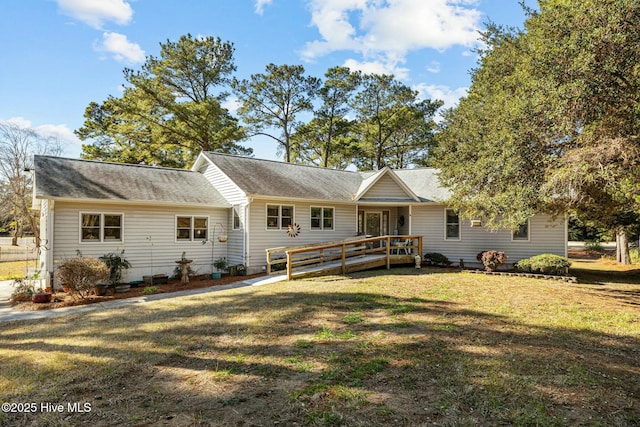 view of front of home with a wooden deck and a front lawn