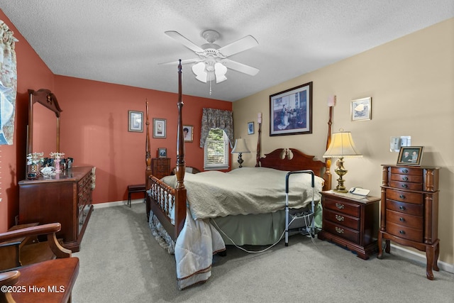 carpeted bedroom with ceiling fan and a textured ceiling