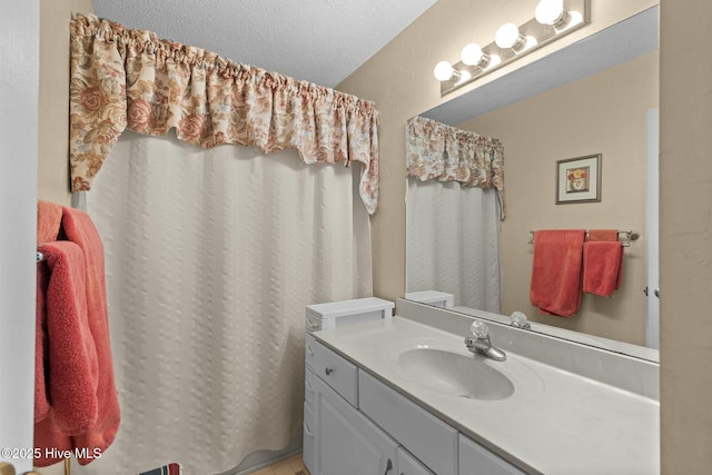 bathroom featuring a textured ceiling and vanity