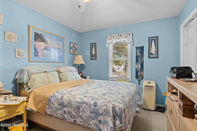 carpeted bedroom with a closet and a textured ceiling