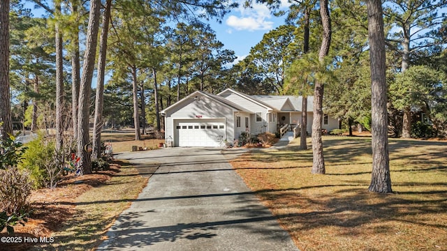 view of front of property featuring a front yard and a garage