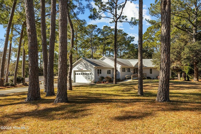 ranch-style house with a garage and a front yard