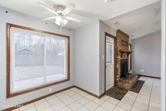 unfurnished living room with light tile patterned floors, ceiling fan, a fireplace, a textured ceiling, and vaulted ceiling