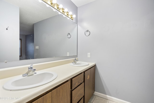 bathroom with vanity, tile patterned floors, and a textured ceiling